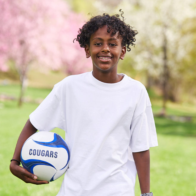 African American boy holding soccer ball