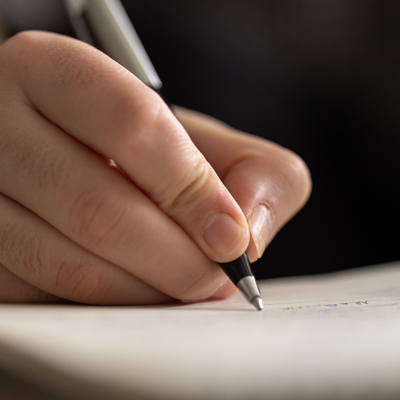 close up of hands taking notes