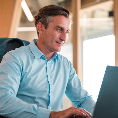male teacher using a laptop