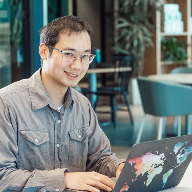 male university student using laptop